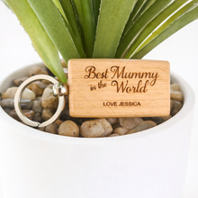 Load image into Gallery viewer, Wooden keychain with engraved message in a pot with plants