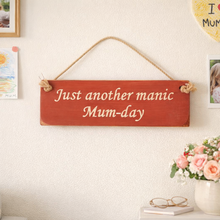 Load image into Gallery viewer, Red wooden sign with natural text hanging on a wall, with a vase of flowers and books in the background.