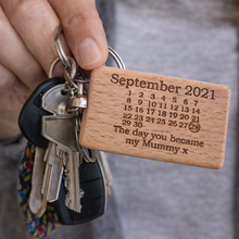 Load image into Gallery viewer, Keychain with wooden tag displaying a message about a special date, held by a person. Mothers day ift