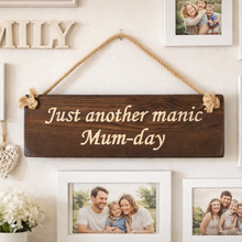 Load image into Gallery viewer, Decorative wall sign with 'Just another manic Mum-day' text, surrounded by family photos on a wall.